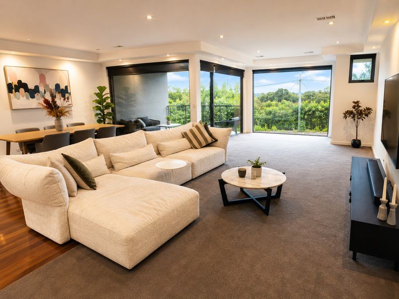 Spacious lounge with large windows and garden outlook