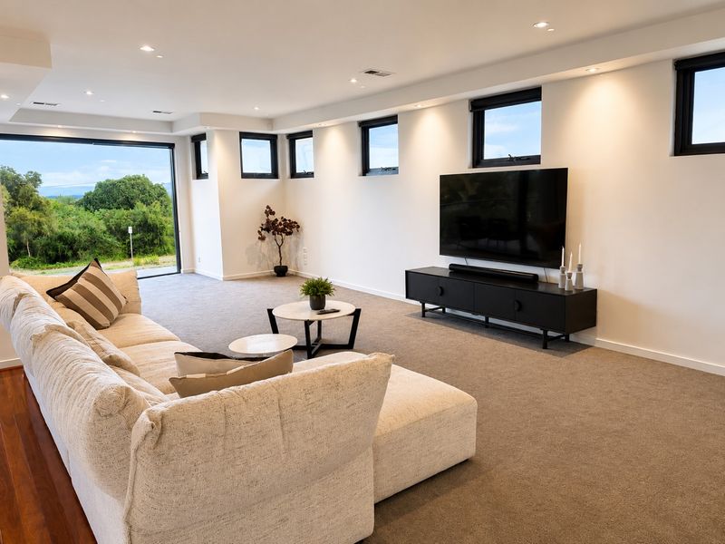 Second living area with television and bay-facing windows