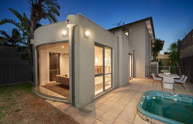 Rear garden, spa and ground-floor entertaining area at dusk